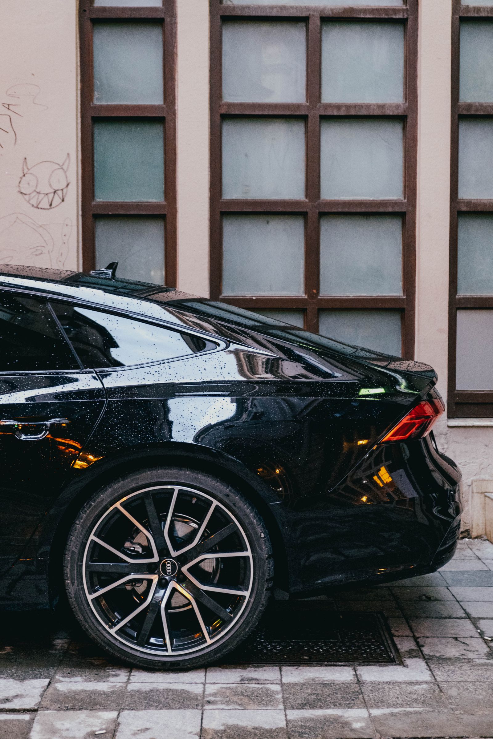 Glossy black car after professional exterior care